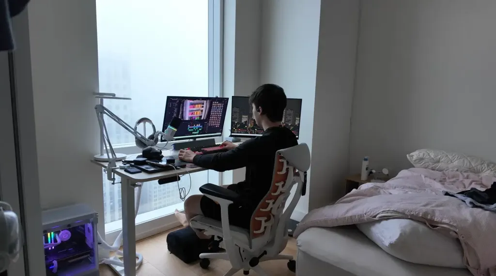 Jason Huang wearing the Nearity Menpod Fit 2 open ear headphones while working from home, demonstrating comfort and focus during remote work sessions.