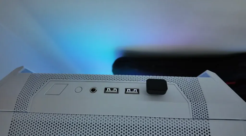 Jason Huang inserting the USB-C dongle of his Nearity Menpod Fit 2 open ear headphones into a laptop, highlighting seamless connectivity for work calls and PC use.