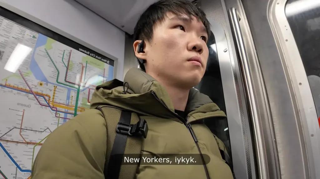 Jason Huang wearing the Nearity Menpod Fit 2 open ear headphones while commuting on the subway, highlighting situational awareness and comfort for urban professionals.