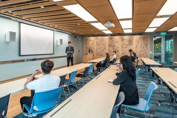 Teacher teaching students in a modern classroom training environment.
