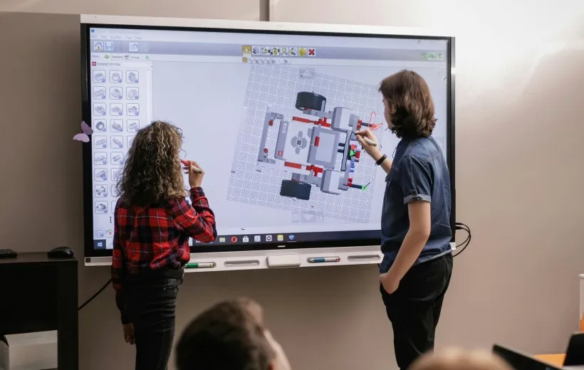 two people working on the smartboard.jpg