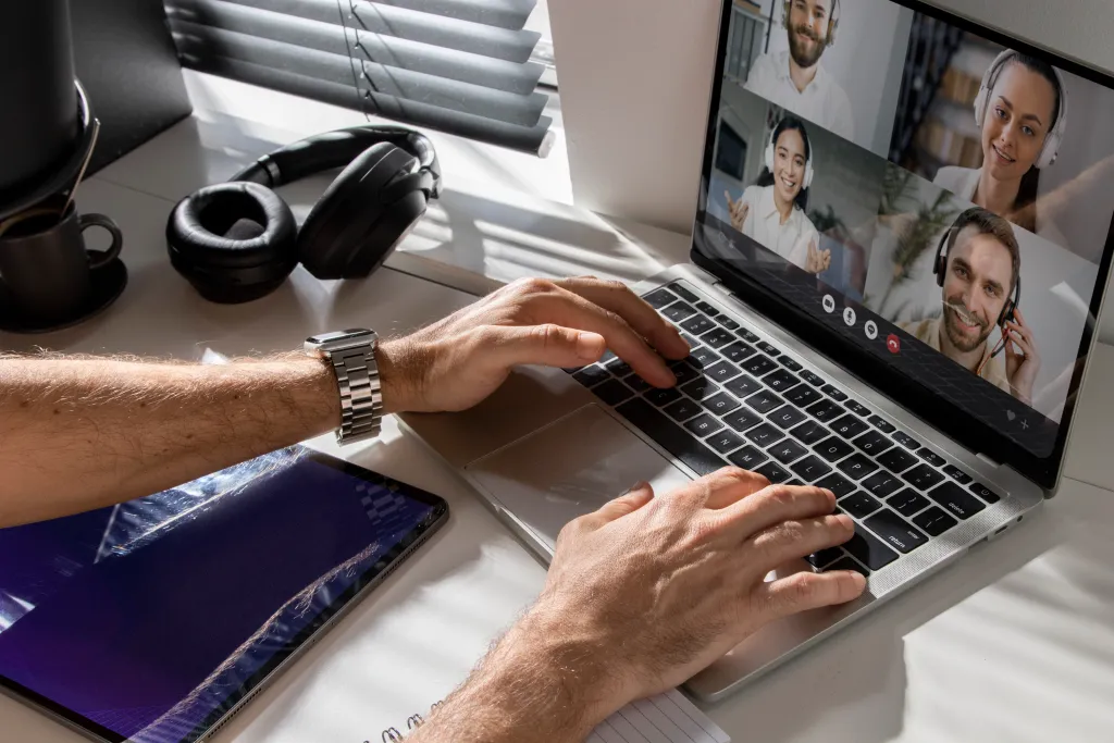 Close-up of a remote worker in a video meeting, using a 4K webcam and a noise-canceling headset to maintain professional communication in a modern apartment.