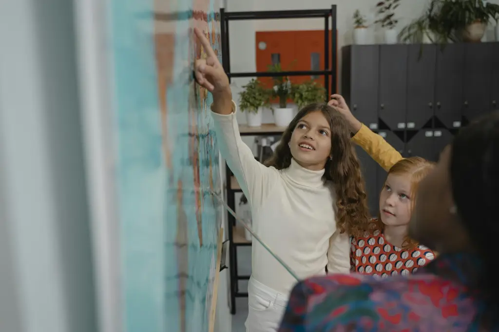 Students collaborating on a science project directly on a whole class whiteboard