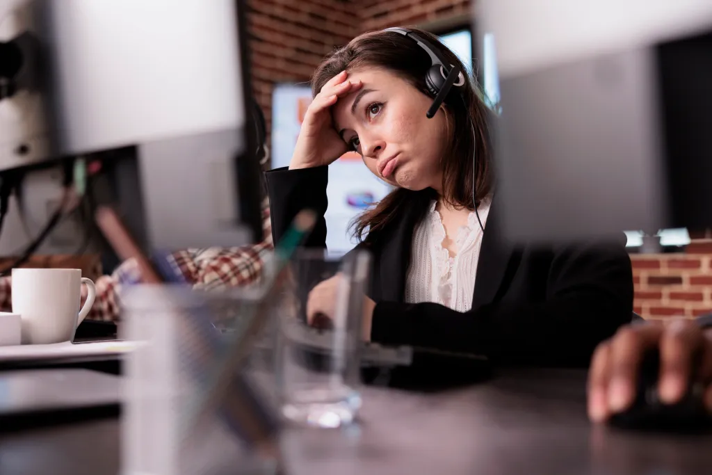Woman looking frustrated while her headphones are not working
