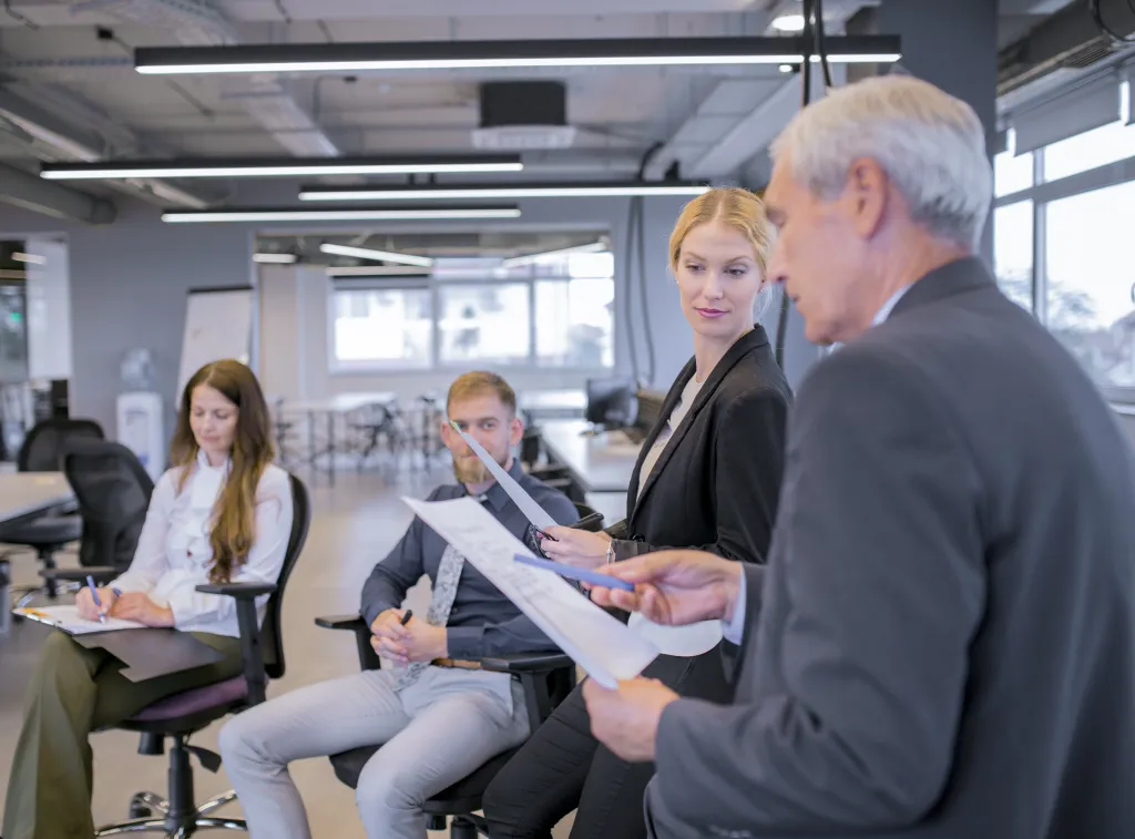 young-businesswoman-looking-senior-businessman-pointing-documents-his-hand.jpg