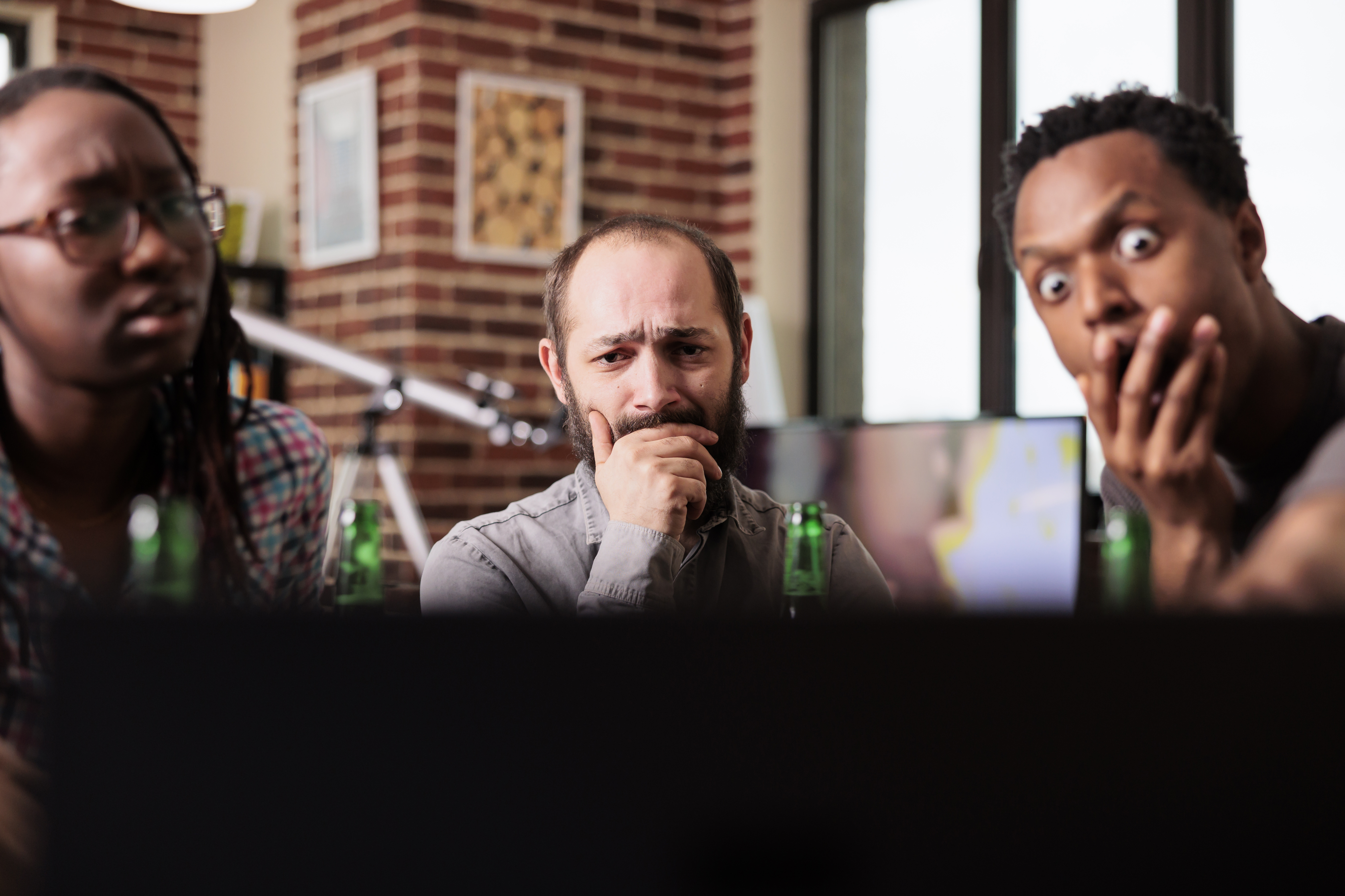 astonished-diverse-group-friends-sitting-home-while-watching-tragic-news-events-online-modern-laptop-multiethnic-people-sitting-table-living-room-while-watching-videos-internet.jpg