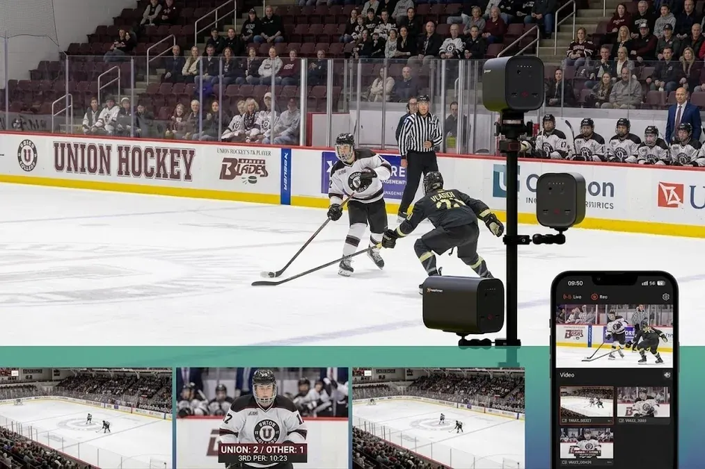 Ice hockey live streaming setup at indoor rink with camera mounted on plexiglass barrier and clean ice surface visible