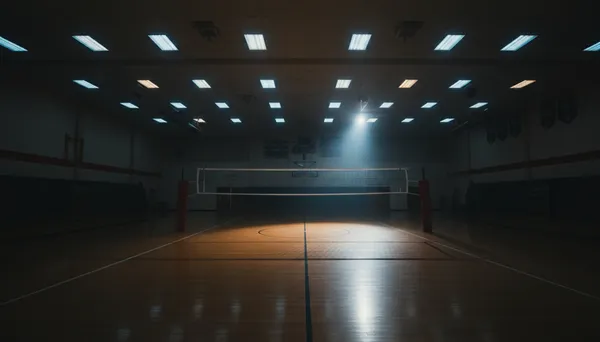 A dimly lit gymnasium showing challenging overhead LED lighting conditions that make indoor volleyball recording difficult without proper exposure control