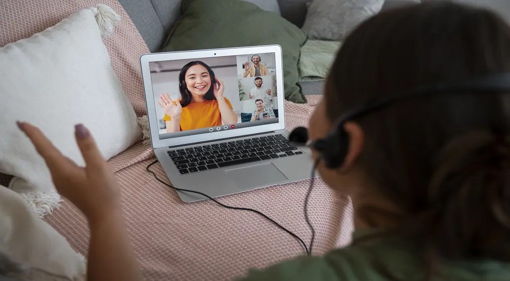 Woman wearing a headset with good-quality mic during a video conference for communication clarity