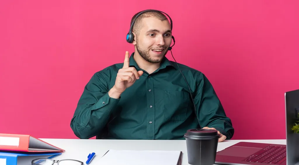 A man wears an office headset with a noise-cancelling mic positioned near the mouth for clear calls