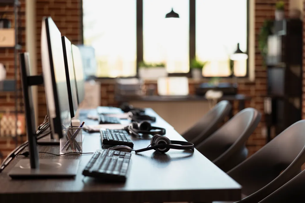 A professional agent wearing the best noise cancelling headset for call center while working in a busy office environment, highlighting the efficiency of a wireless headset for call center.