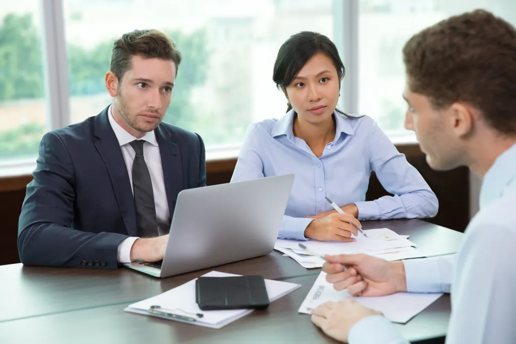 Picture of legal professionals analyzing case with client in office