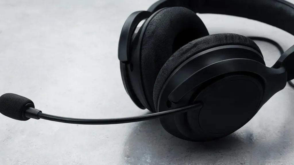 Product detail shot of a modern black over-ear communication headset with boom microphone