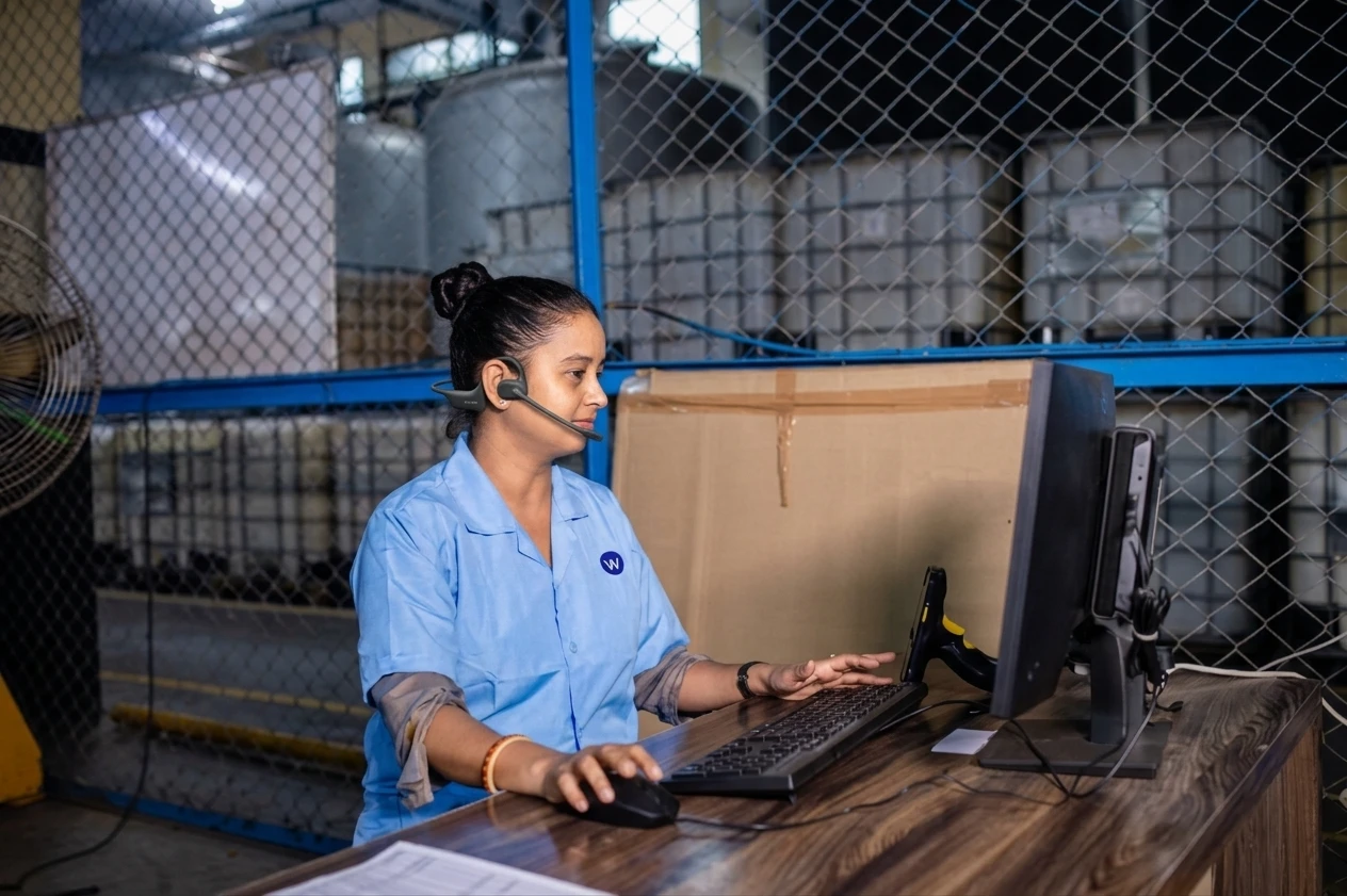 Plant manager transitioning from office to manufacturing floor with headset