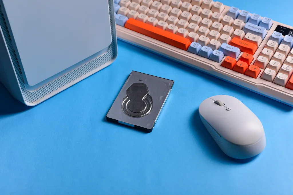 A colorful mechanical keyboard and mouse setup, demonstrating the typing noise that requires the best noise cancelling headphones for coding.