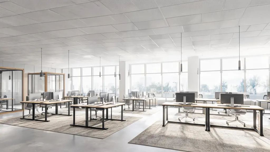 Wide shot of a contemporary open office with ergonomic workstations standing desks and glass meeting rooms with bright airy atmosphere