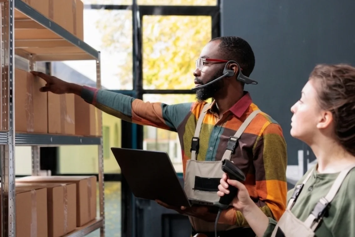 Inventory specialist checking stock with open ear headset