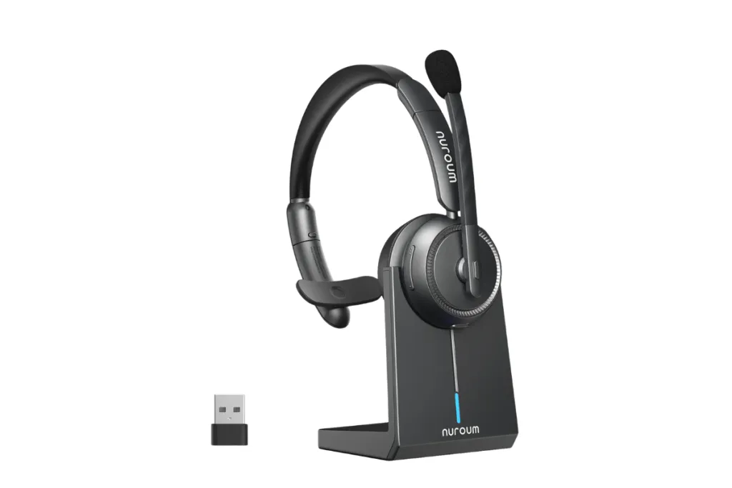 A Nuroum single-ear wireless headset sitting on its charging dock alongside a USB Bluetooth adapter.