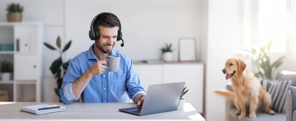 Remote worker wearing closed back headset with microphone while attending an online meeting from home.