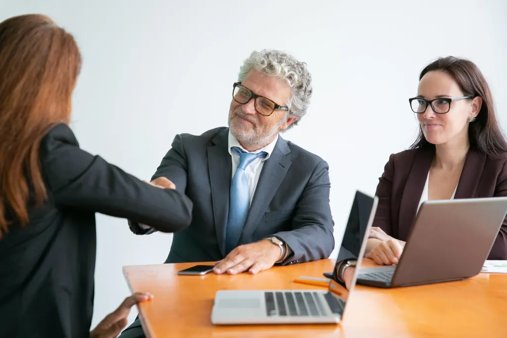 A lawyer shaking hands with a client to build trust and rapport during a successful legal consultation.
