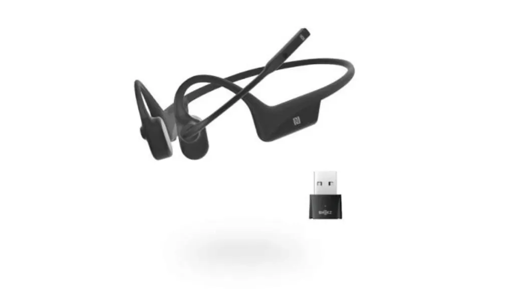 Black Shokz OpenComm bone conduction headset with boom microphone and USB wireless adapter.