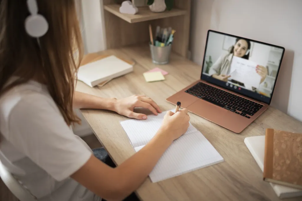 An interactive digital lesson displayed on a laptop screen, showing a teacher using the wireless headphone for online teaching.