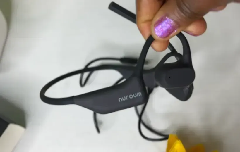 there is a hand holding wfh headset